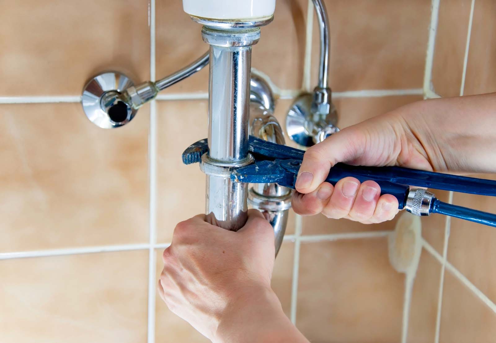 plumber with sink and wrench